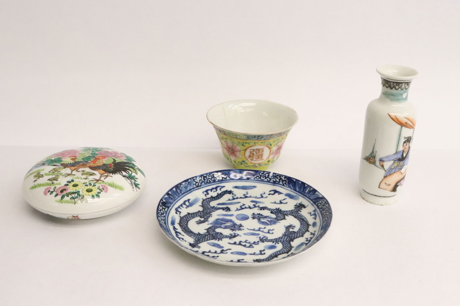 4 pieces Chinese vintage porcelain: 4 pieces Chinese vintage porcelain(0.1.65"x4.2"dia - 4.85"x1.7"dia); the blue and white porcelain plate (0.9"x5.65"dia) has a chip on rim, the famille rose porcelain tea cup (2.15"x3.6"dia) has hairli