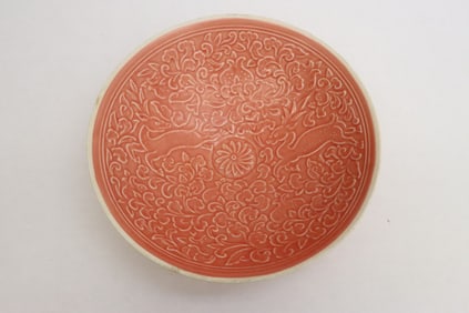 A pink glazed porcelain bowl