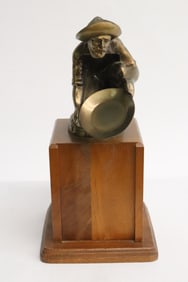 Metal sculpture of gold digger