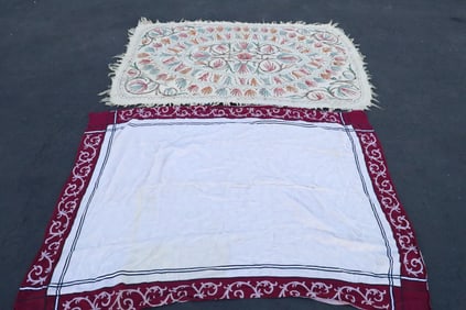 a floral design rug, and a fancy table cloth