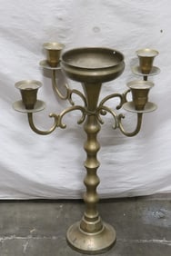 A large brass/ bronze floor candle holder