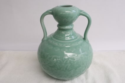 A light green glazed porcelain handled vase