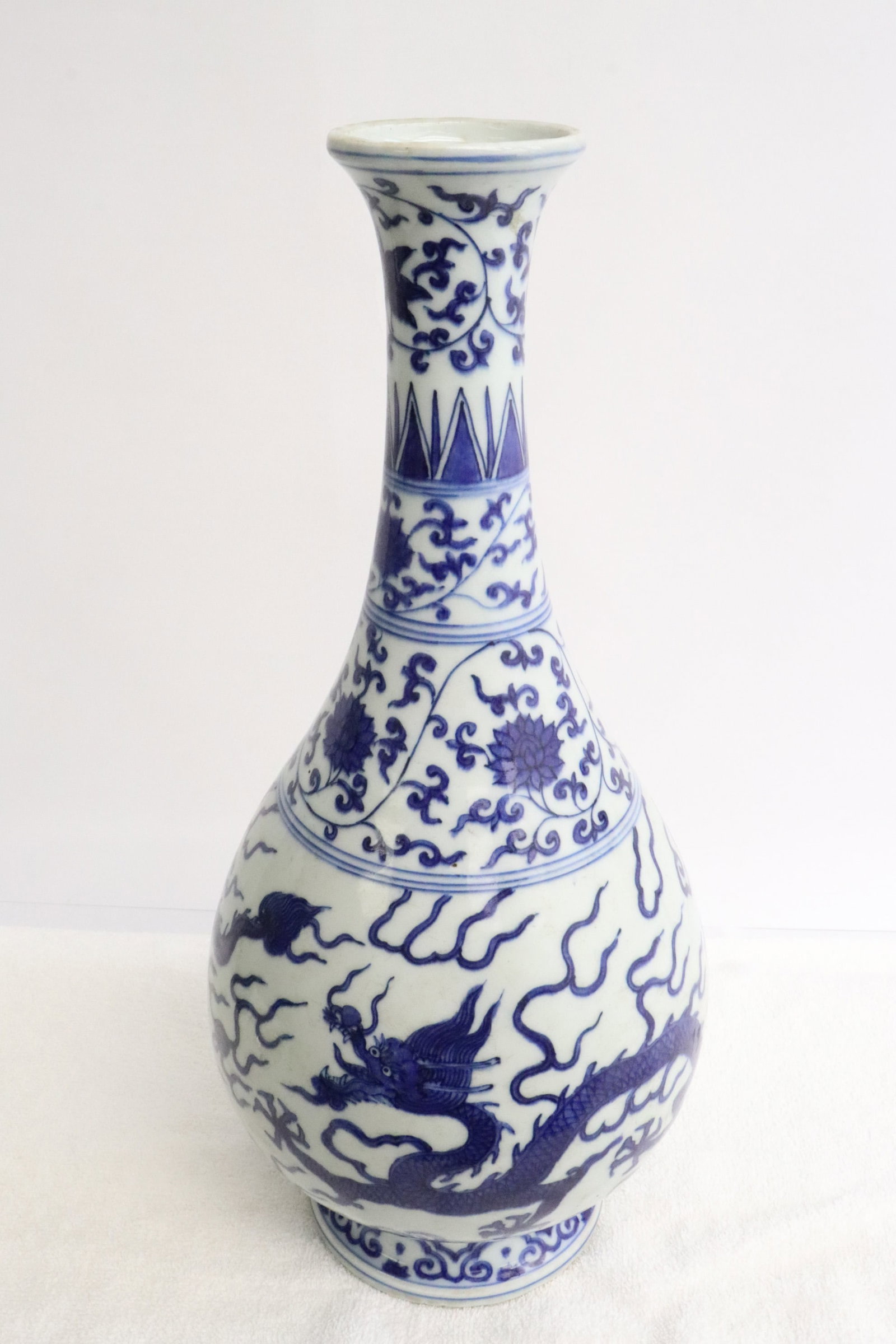 A blue and white porcelain vase: A blue and white porcelain vase with dragon motif decoration, 14.4"x6.6"dia