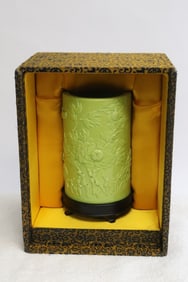 A green glazed & carved porcelain brush holder