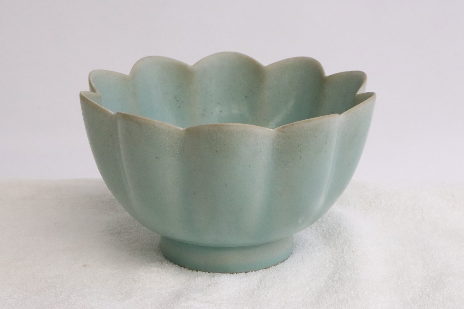 A light celadon porcelain bowl with fluted edge: A light celadon porcelain bowl with fluted edge, 4.1"x6.8"dia