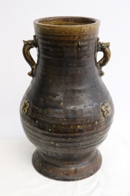 A brown glazed earthenware jar