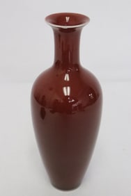 A red glazed porcelain slender vase