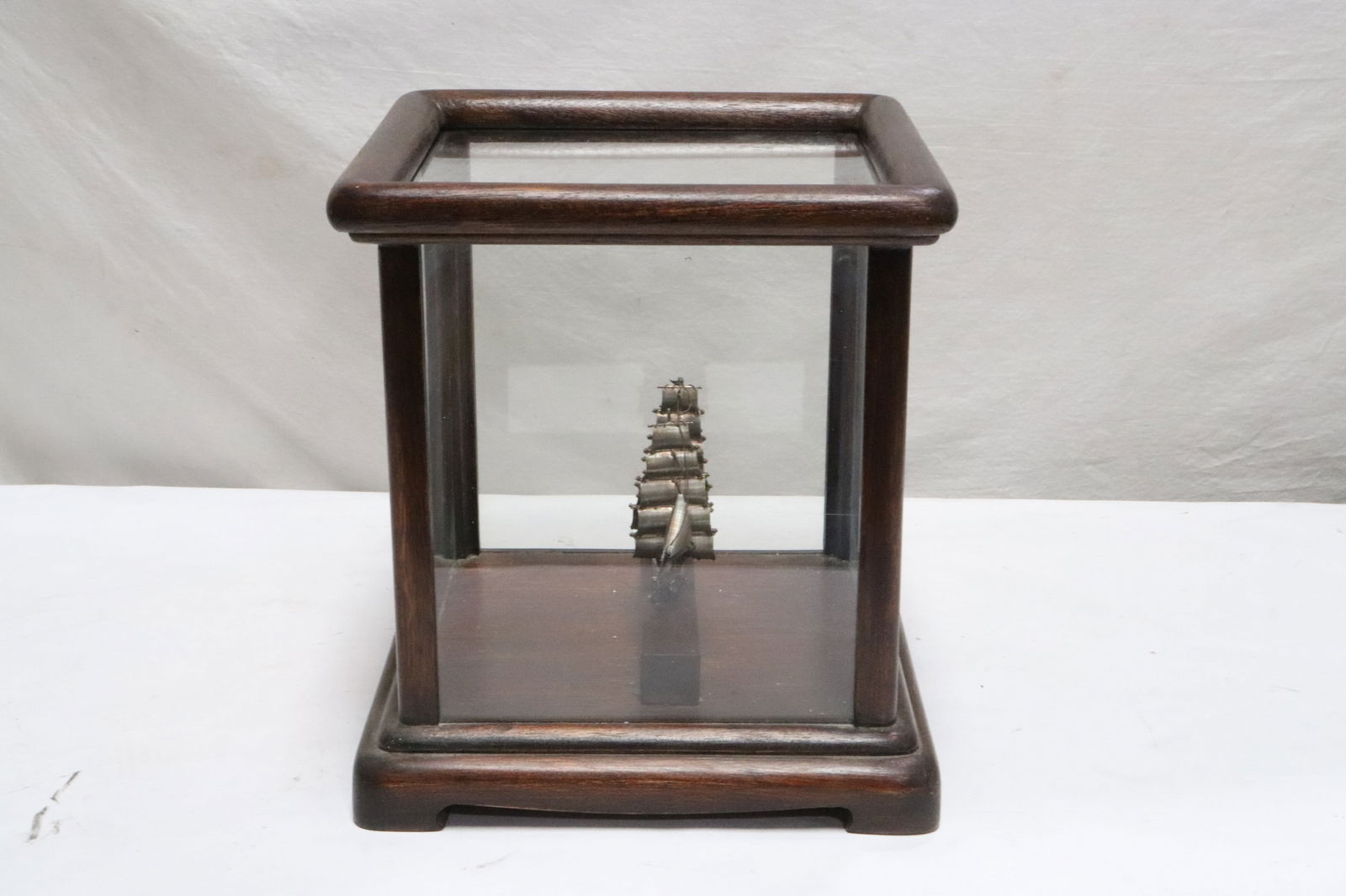 A sterling silver boat in display case, artist signed