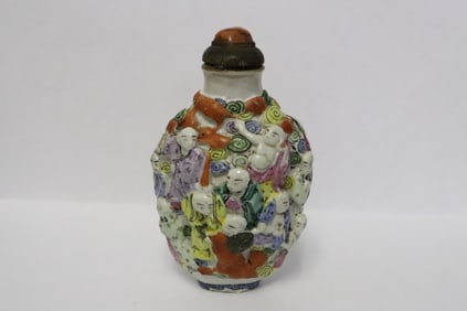 Chinese 19th c. famille rose relief figure snuff bottle