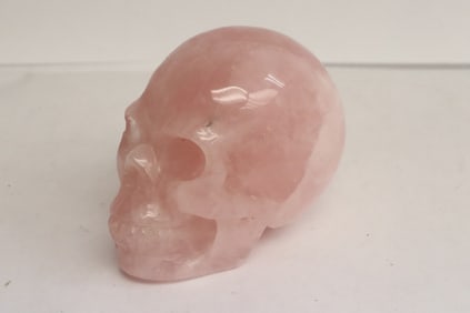 A rose quartz carved skull
