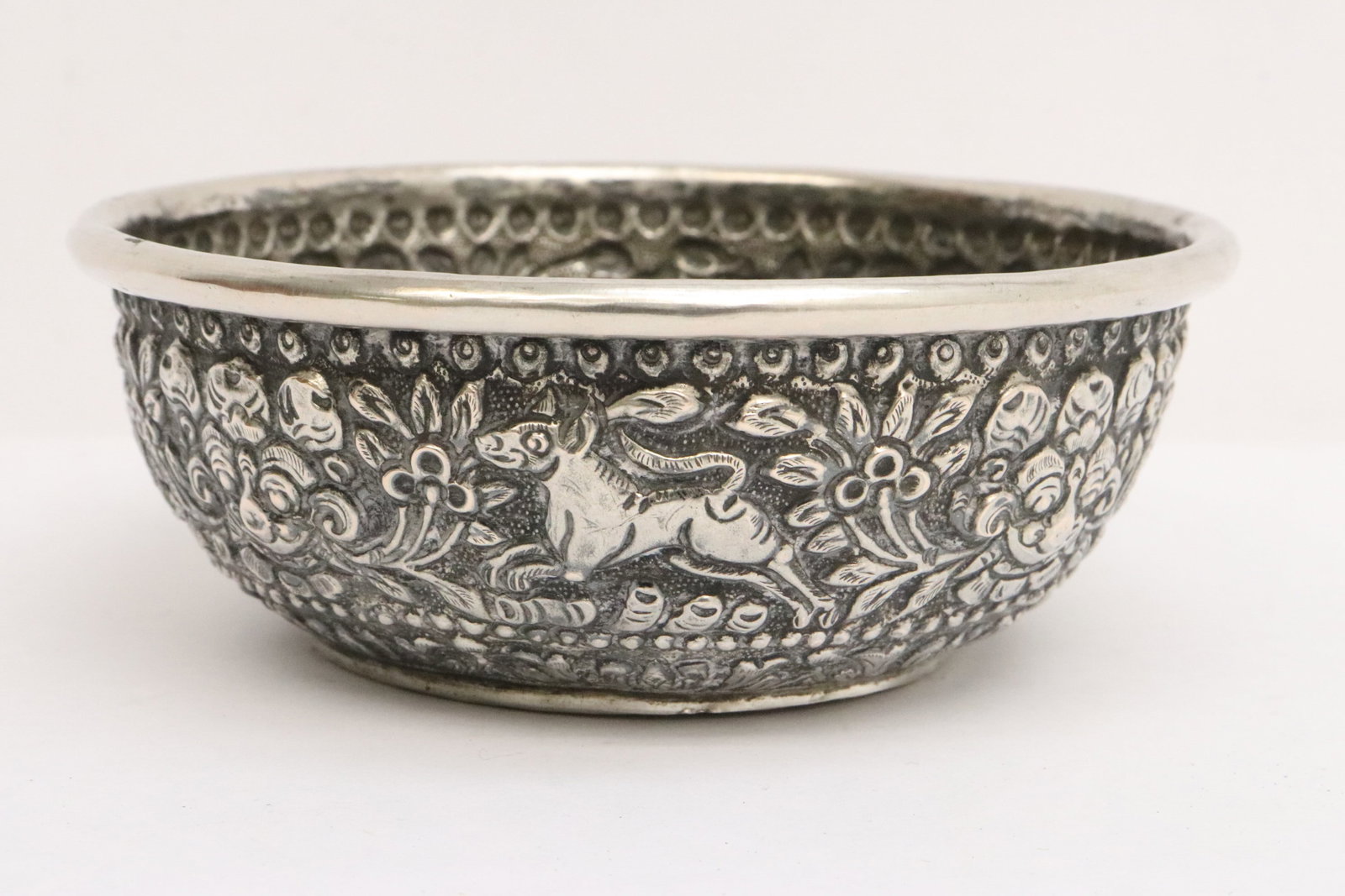 Silver round bowl: Silver round bowl (test positive for silver, content unknown) with decoration in relief, wt. 93.5gm, 1.75"x4.75"dia