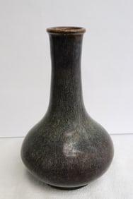 A brown glazed bottle vase