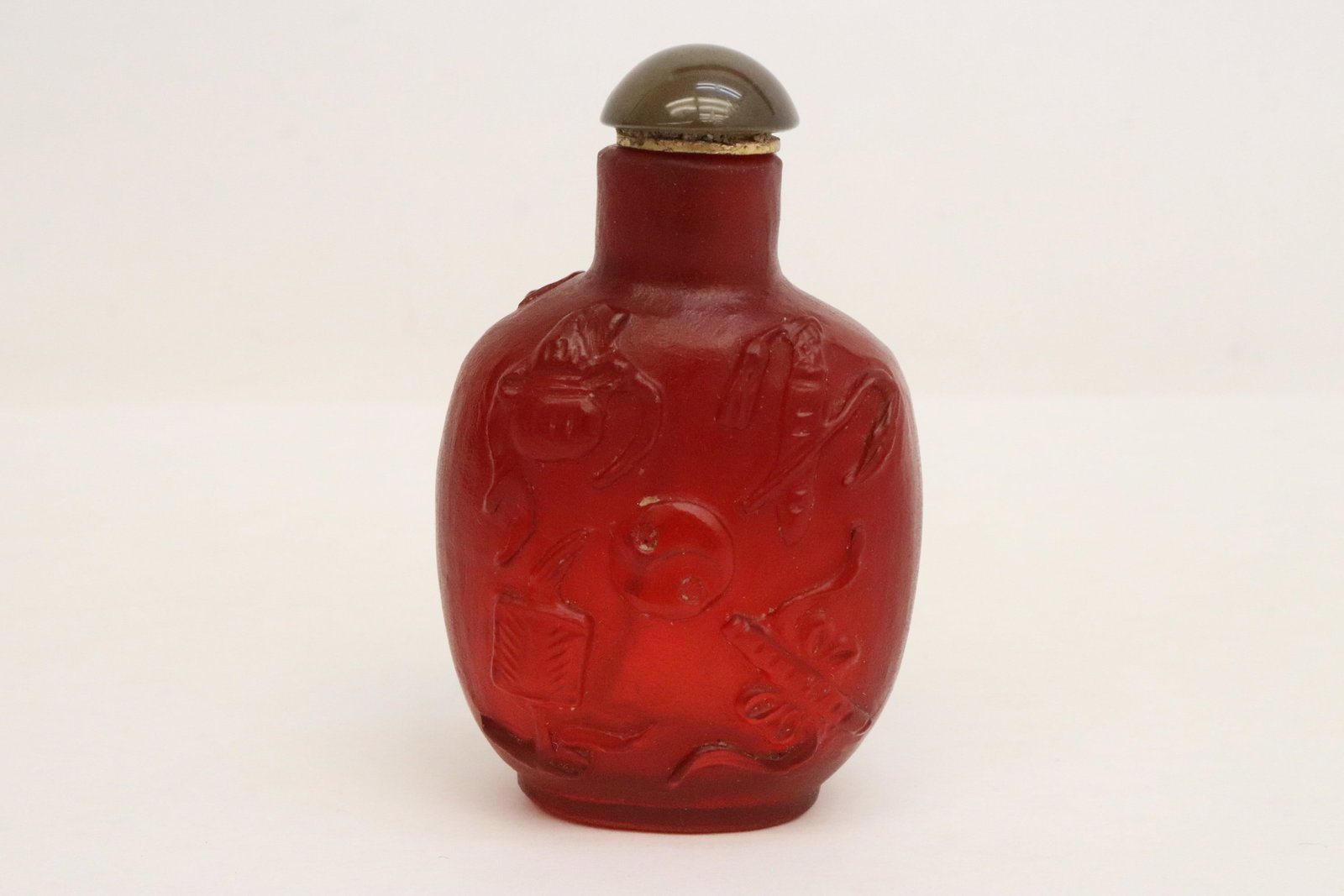 A red on red overlay Peking glass snuff bottle: A red on red overlay Peking glass snuff bottle, 3"x1.85"x1.3"
