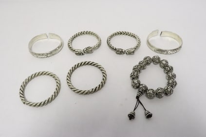 7 White metal bracelets