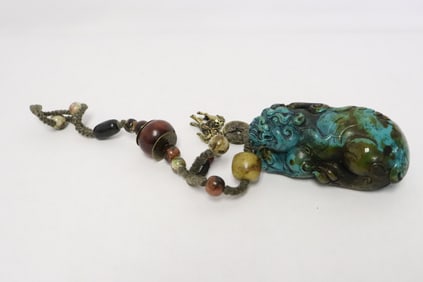 A resin sculpture of qilin with attachment