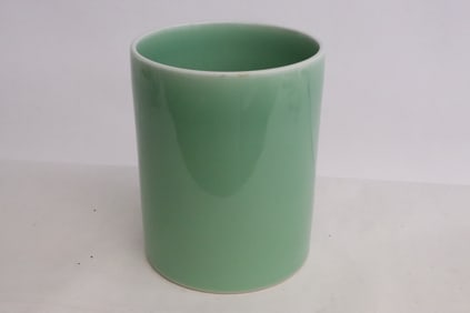 A light green glazed porcelain brush holder