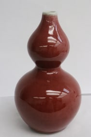 A red glazed porcelain gourd shape vase