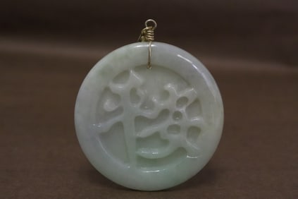 A light apple green jadeite carved pendant