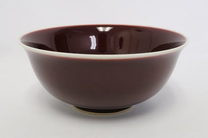 A red glazed porcelain bowl