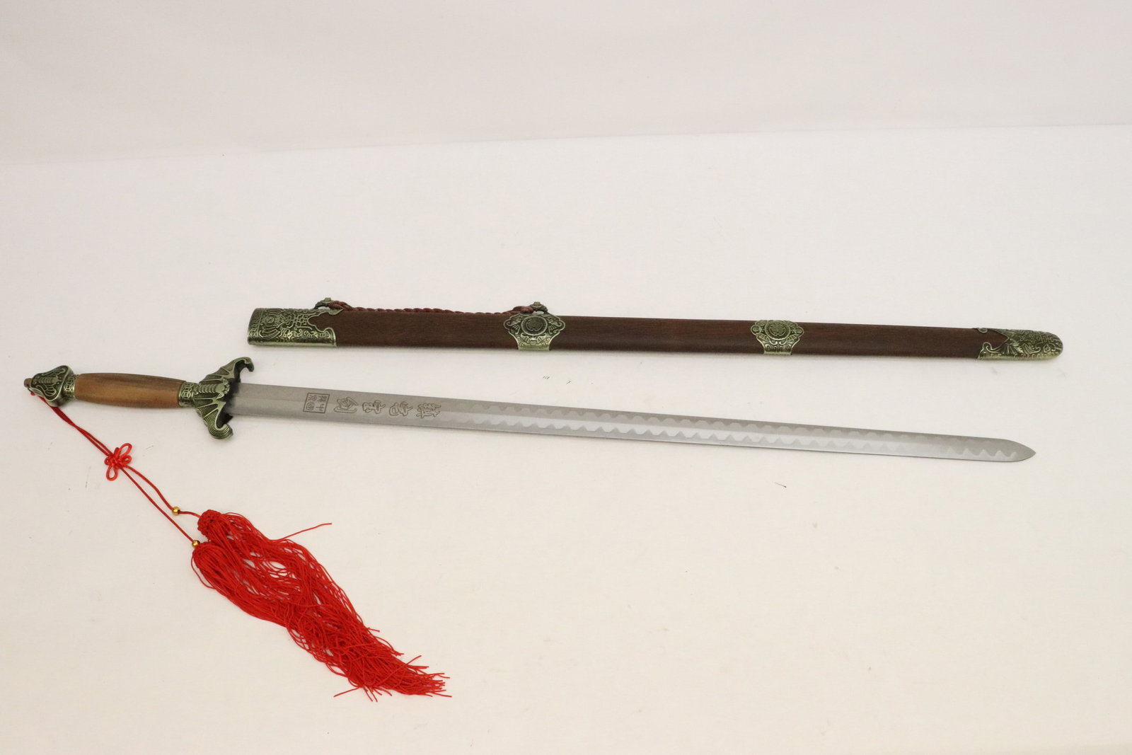 A Chinese sword with jichi wood style scabbard: A Chinese sword with jichi wood style scabbard, 39.5"L