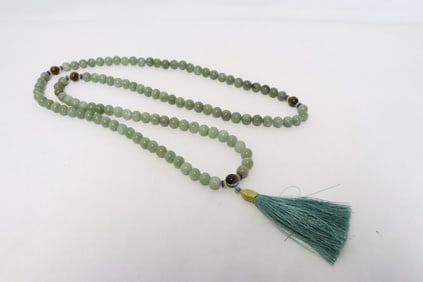 A long jade like stone carved necklace