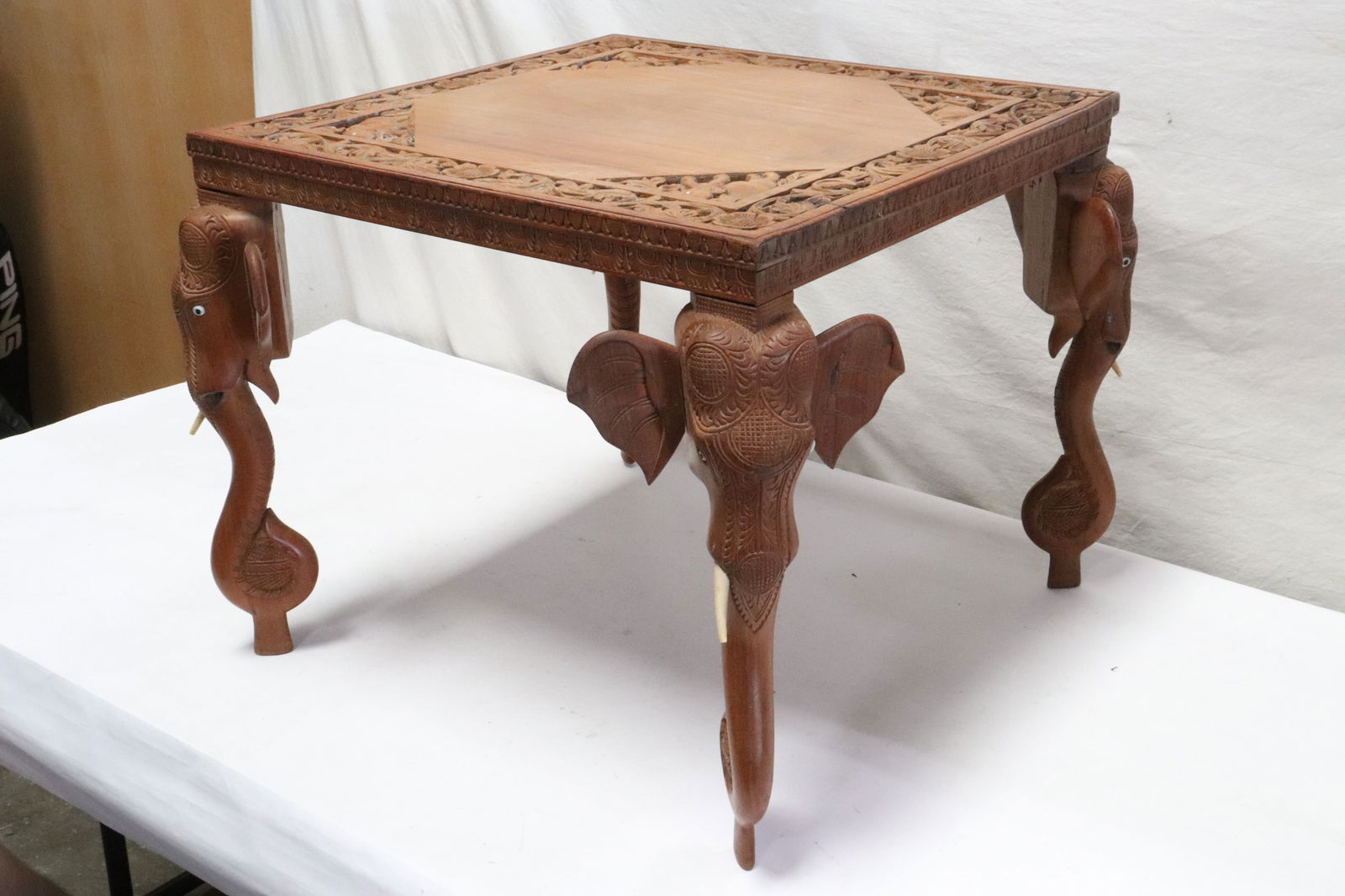 A teak wood table with elephant motif legs (1 of 11)