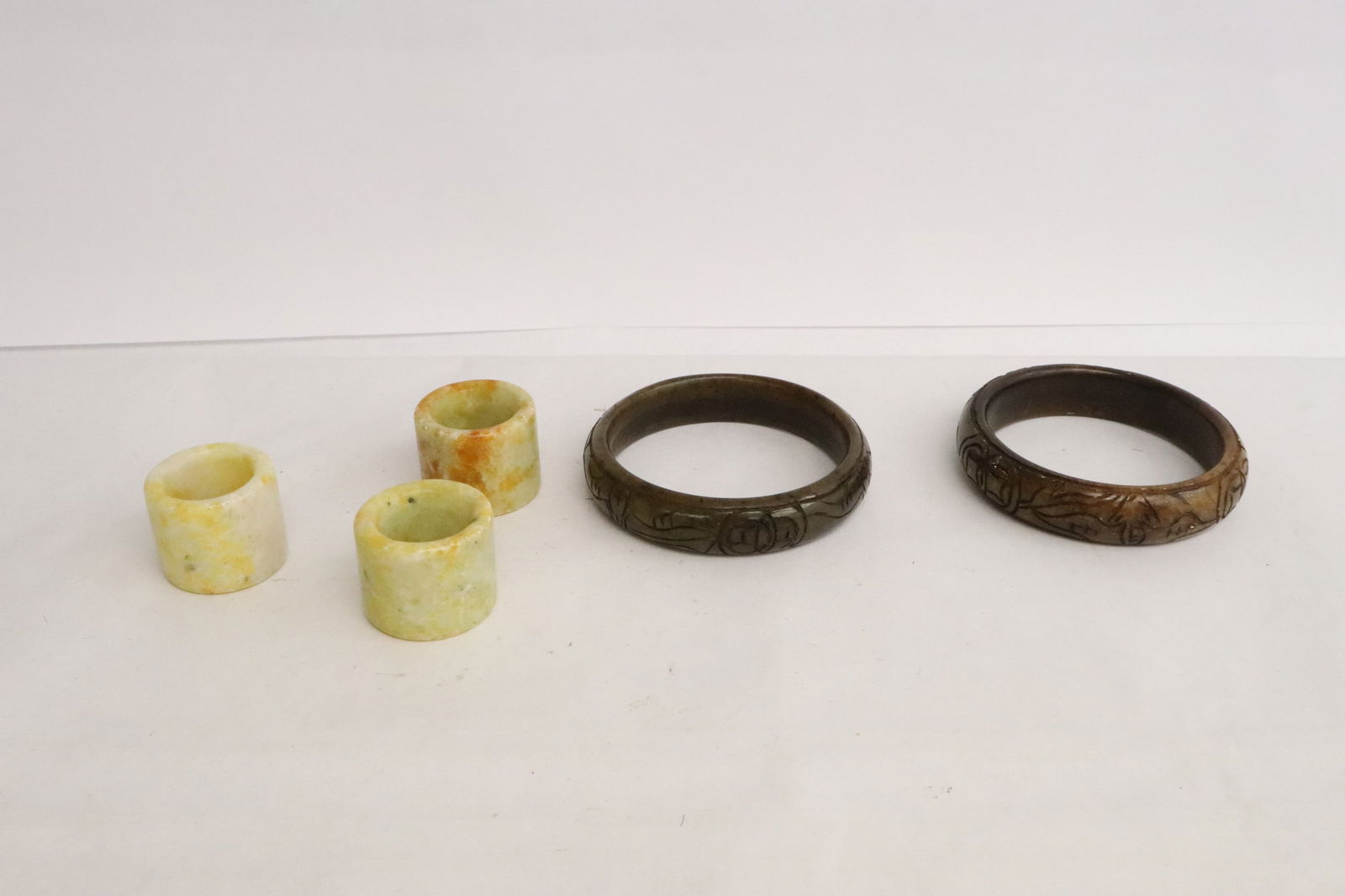 2 stone carved bangles, & 3 stone archer's rings (1 of 11)