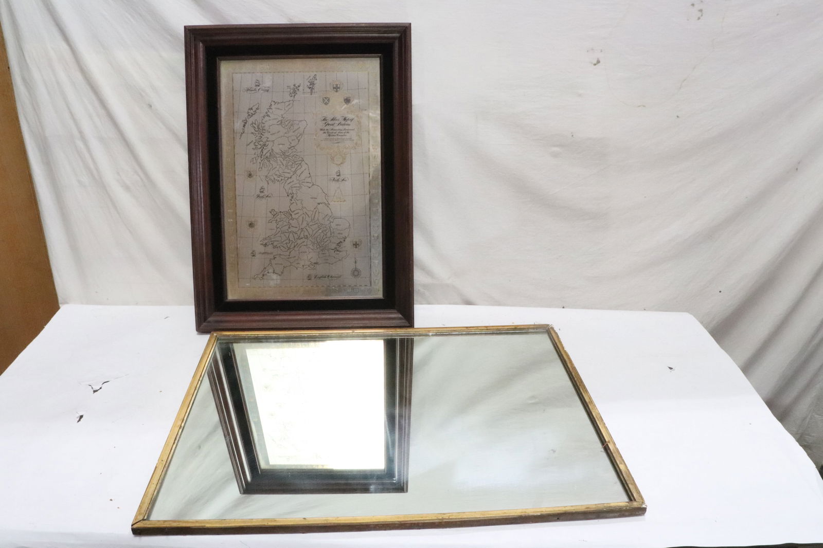 a wall mirror, and a framed mirror style map: 2 pieces; a wall mirror (31"x24"x0.75"), and a framed (27.4"x20"x2") mirror style map