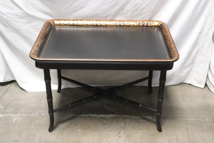 An ebonized tray table