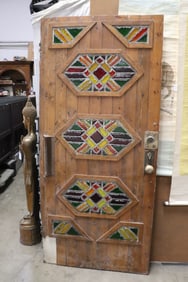 A massive art deco door with art glass decoration