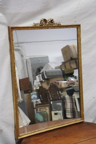 A neo-classic style antique gilt wood framed wall mirror