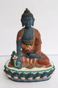 A heavy bronze sculpture of polychrome deity