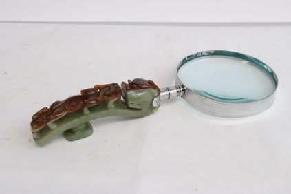A magnifier w/ a jadeite dragon belt buckle as handle