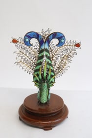 An enamel on brass sculpture of peacock