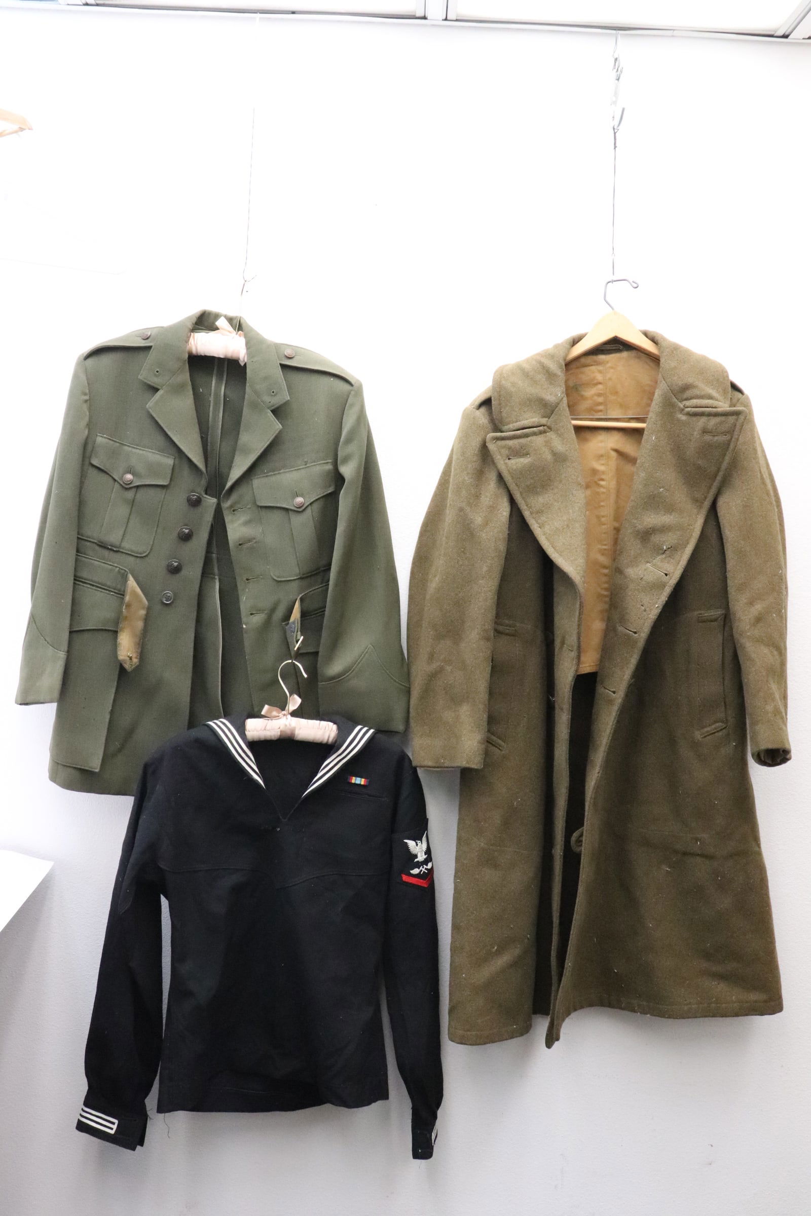 WWI trench coat, WWI officer jacket, & a Navy uniform