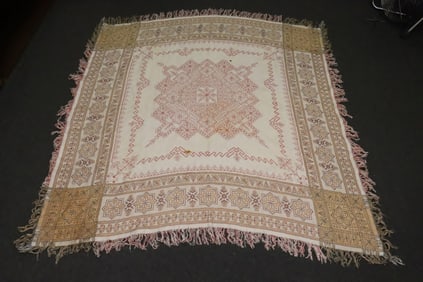 A cross stitch tablecloth, stain