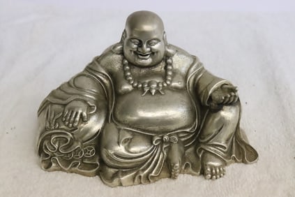 A white bronze sculpture of deity