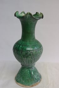 A green glazed earthenware vase