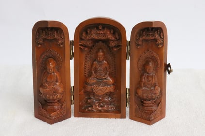 A wood like shrine w/ deity motif decoration in relief