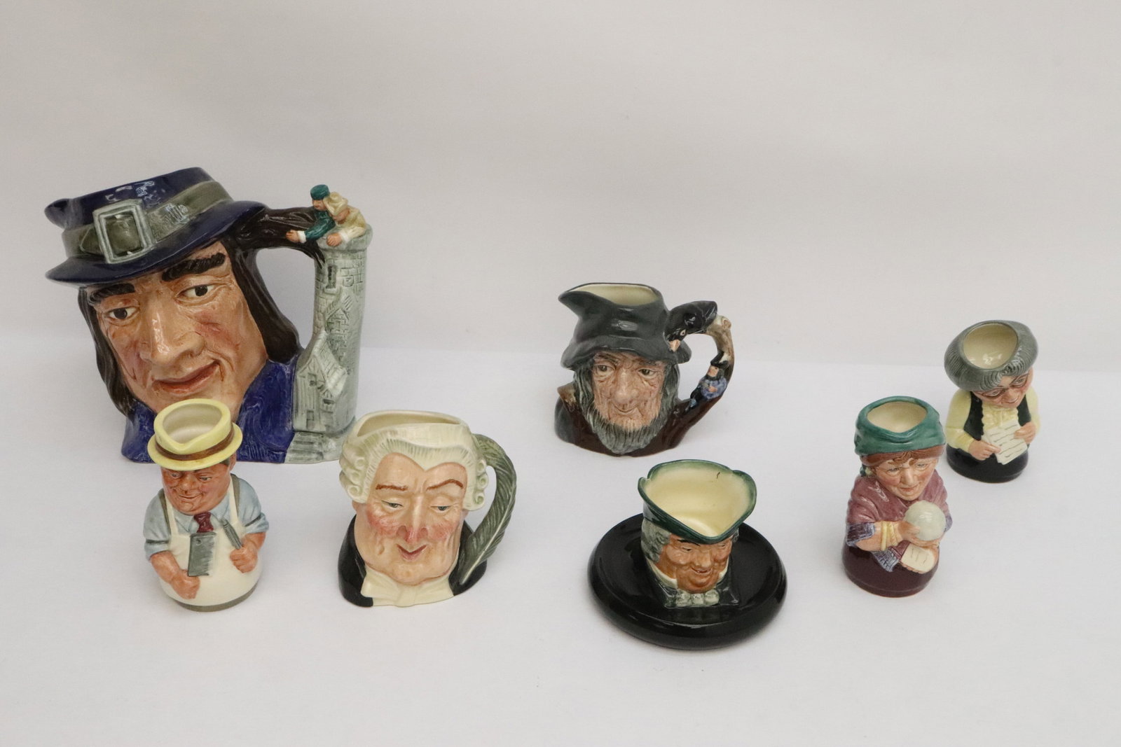 7 Royal Doulton character mugs: 7 Royal Doulton character mugs, 2.8"x4.2"dia - 7.3"x8"x5.5"