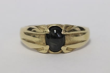 14K Y/G ring, center a black star sapphire cabochon