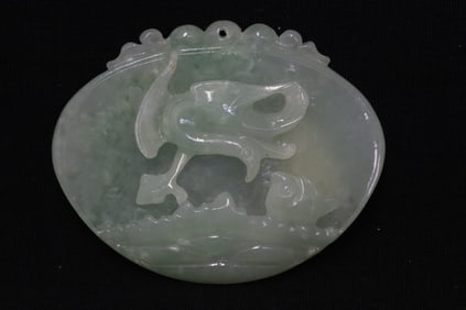 Jadeite pendant with decoration in relief