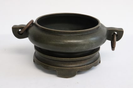 A bronze censer with bronze base