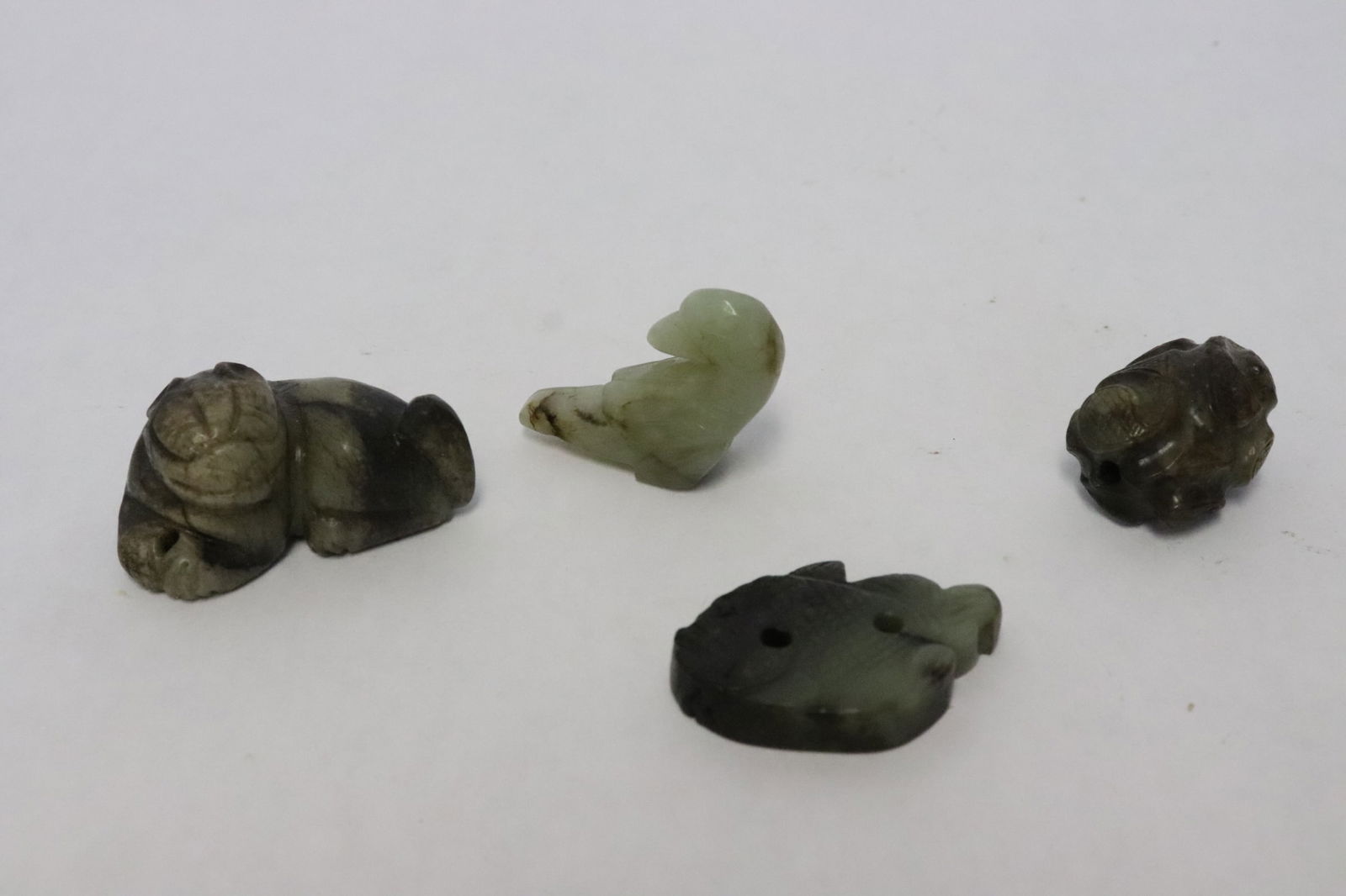 4 Chinese small jade carved ornaments: 4 Chinese small jade carved ornaments, 1.1"x1.4"x0.5" - 0.83"x1.7"x1.15"