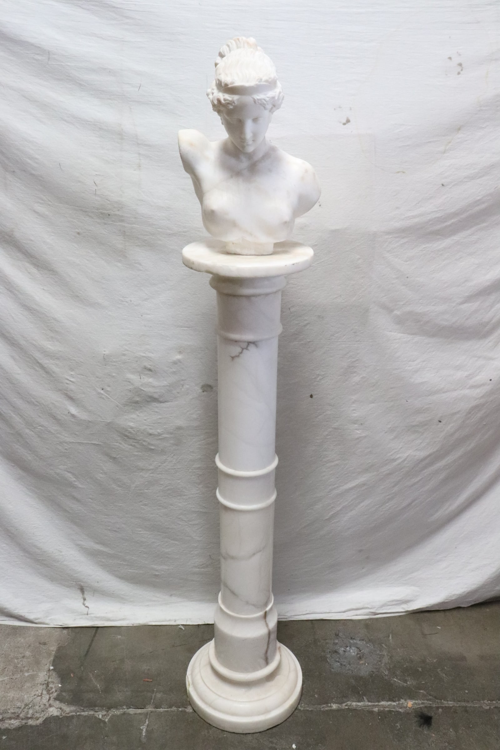 antique marble sculpture on marble pedestal: Beautiful antique marble sculpture of lady's bust (14.65"H) on marble pedestal (43.35"x11.3"dia), it was damage in 1998 San Francisco earthquake, both statue and pedestal has chips and repairs