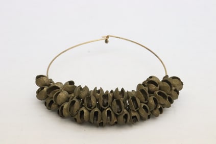 A brass bracelet(?) set with over 50 small bells
