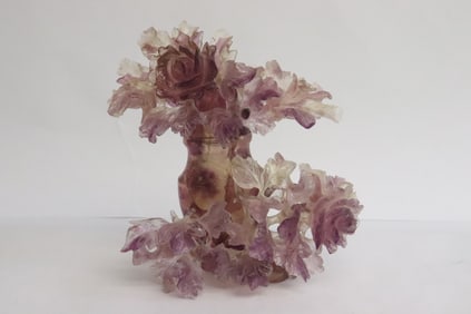 A very elaborate amethyst carved covered vase