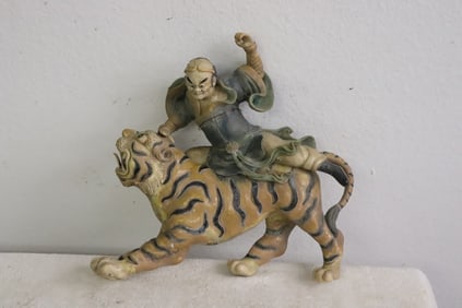 Antique Chinese roof tile depicting warrior on tiger