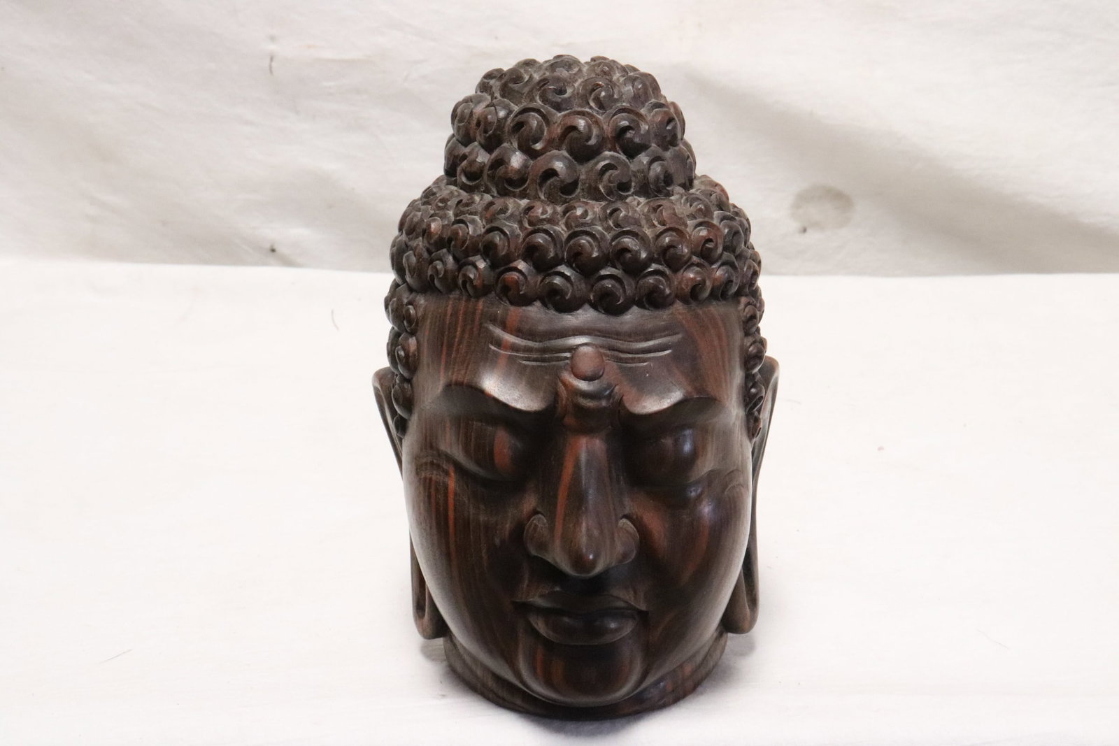 Hardwood carved Buddha head, artist signed: Hardwood carved Buddha head, artist signed on bottom, 7.5"H
