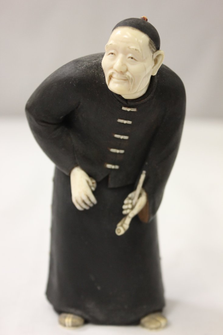 Chinese wood and ivory figure: A fine Chinese wood and ivory figure depicting an old gentleman with pipe, signed 5.4"Hx2.7"X2.7"